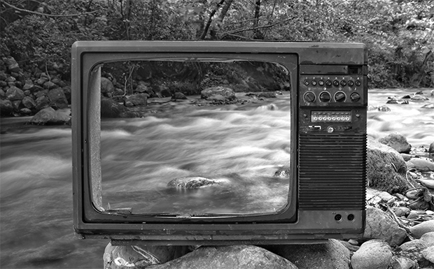 Hollow TV screen with a river behind it