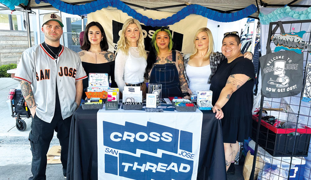 Six people pose in their booth