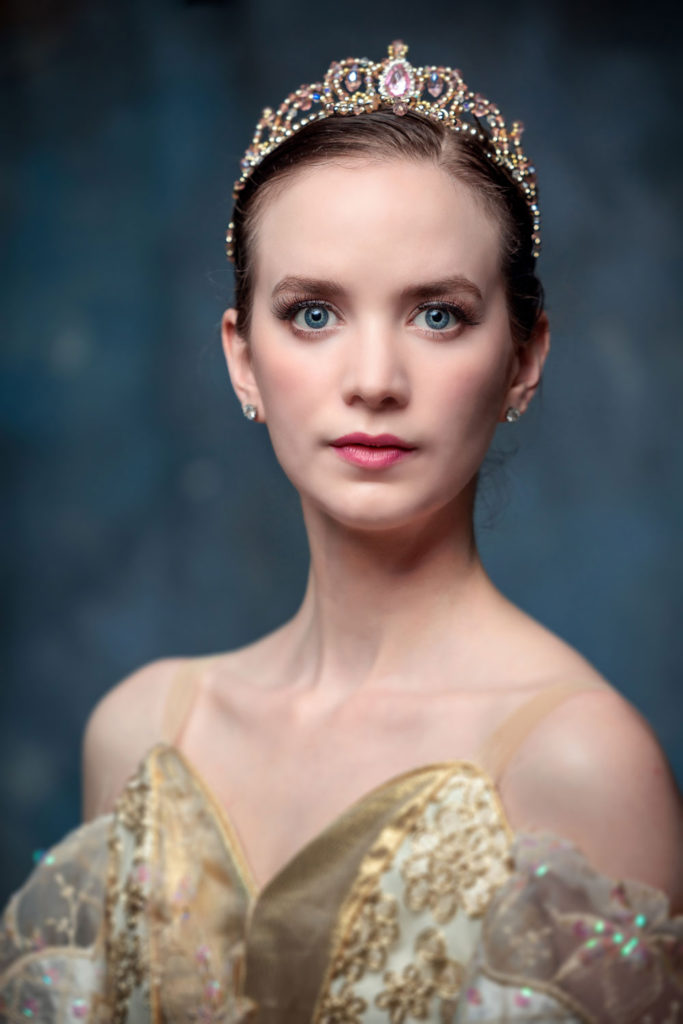 Portrait of dancer wearing a tiara and a decorative outfit.