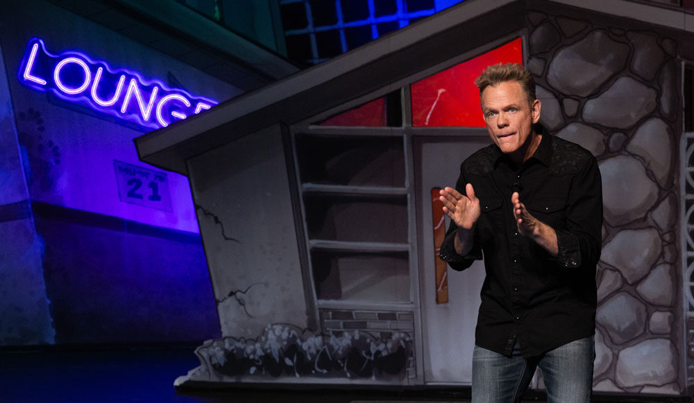 Christopher Titus talking on a stage set