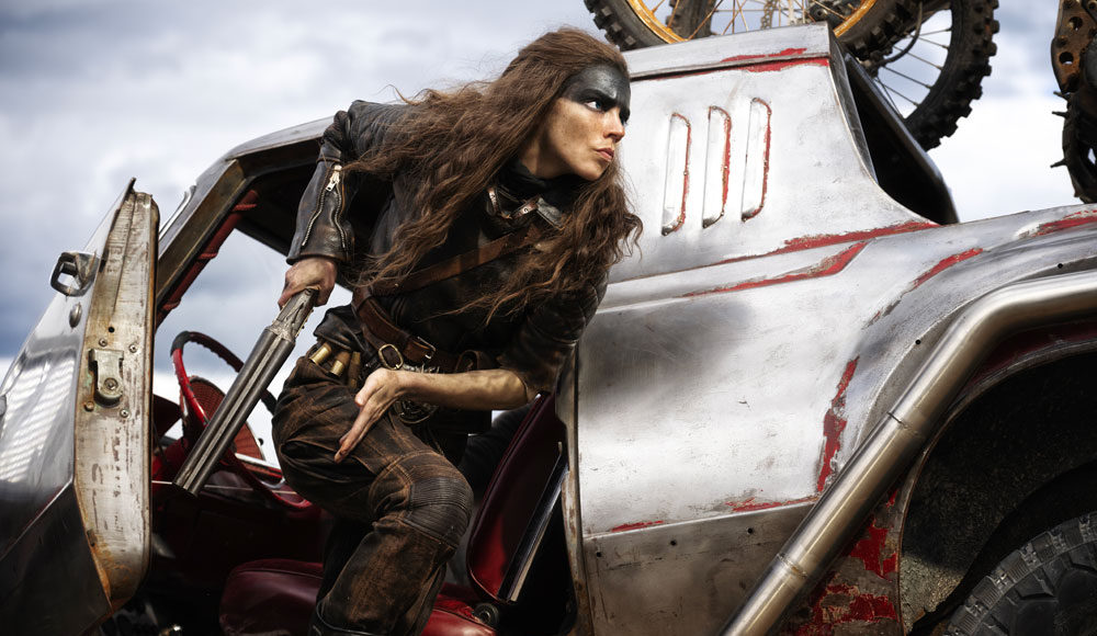 Woman with paint on her face, holding a gun, stands by some sort of vehicle