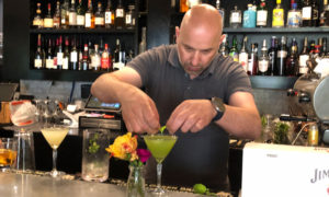 Man mixing a drink at a bar