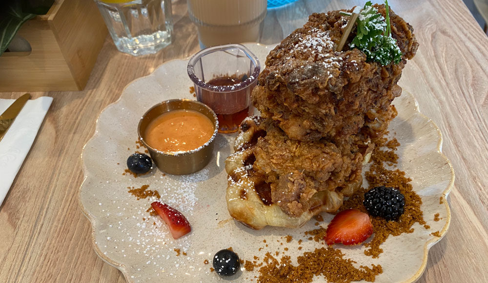 plate with fried chicken on top of a croffle