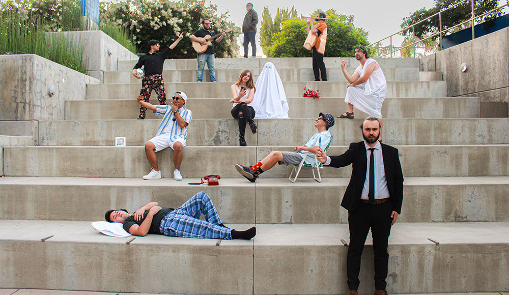 Musicians posing on concrete steps outdoors