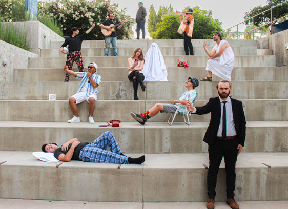 Musicians posing on concrete steps outdoors