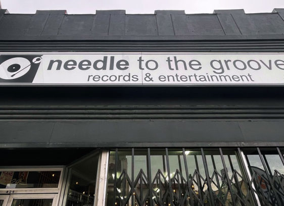 Needle to the Groove storefront with sign