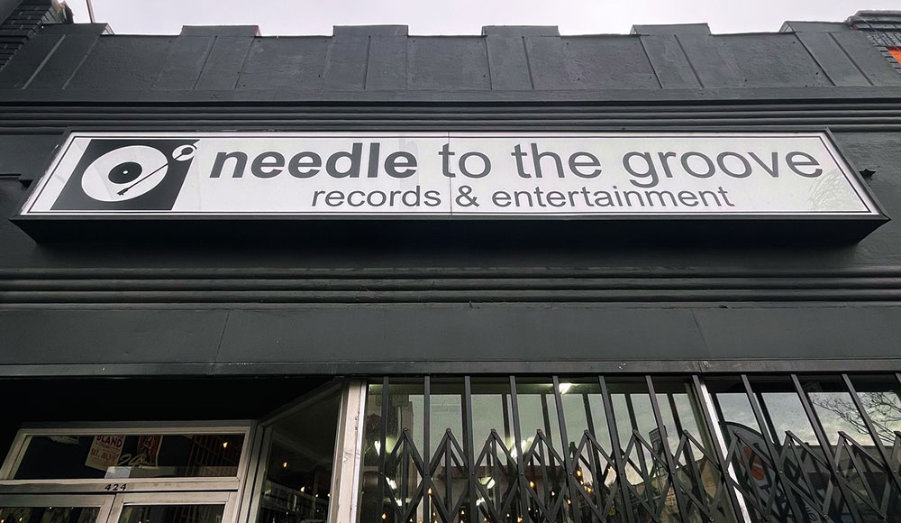 Needle to the Groove storefront with sign