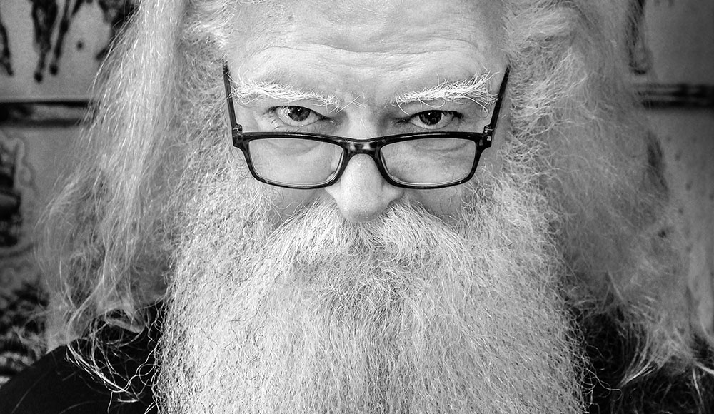 Portrait of bearded man wearing dark-framed glasses