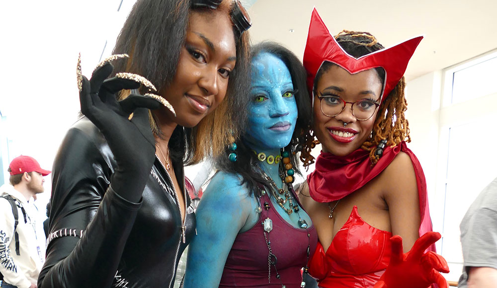 Three women dressed as science fiction/superhero costumes