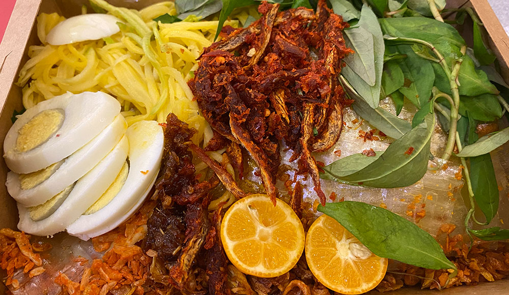 Vietnamese food in a takeout container