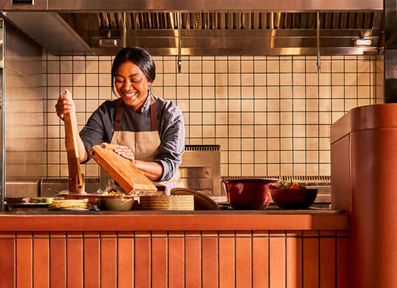 Woman cooking in an open kitchen