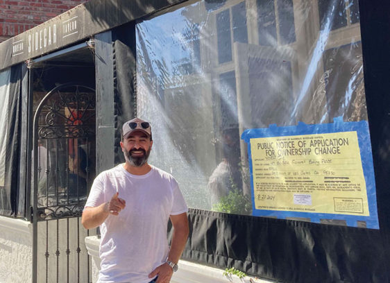 Man standing in front of a storefront under construction