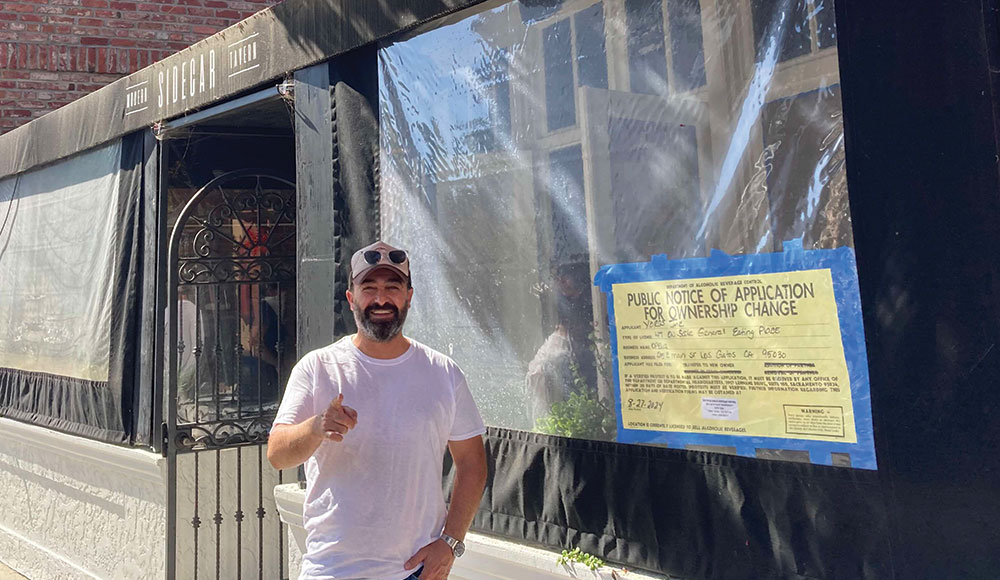 Man standing in front of a storefront under construction