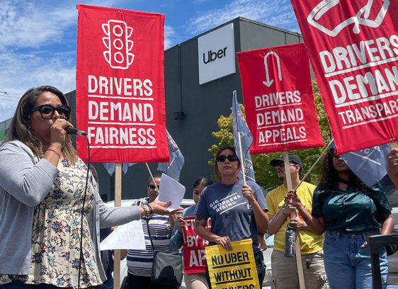 Rideshare drivers holding up signs