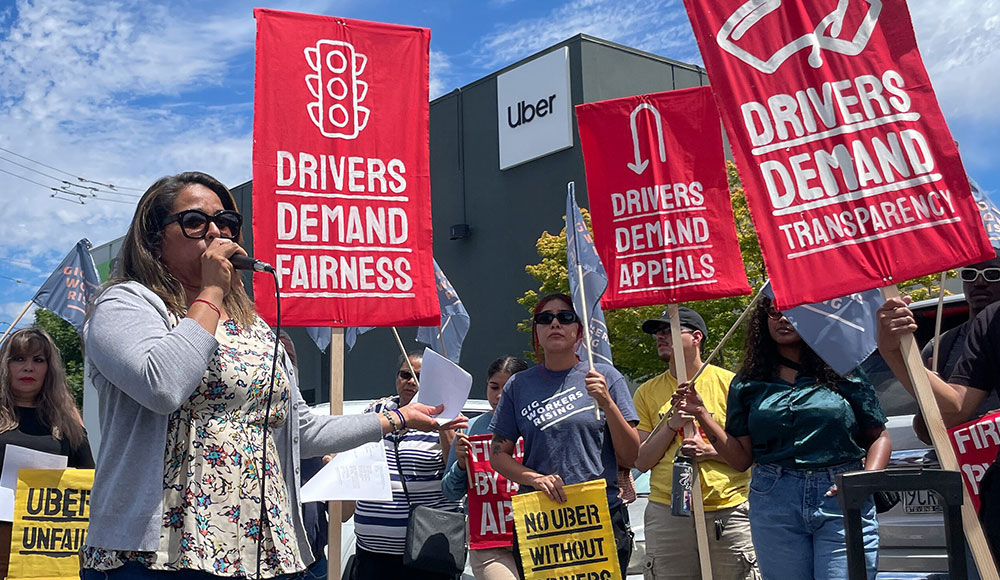 Rideshare drivers holding up signs