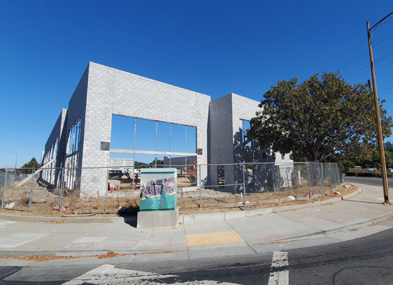 Building under construction in an empty lot on a corner