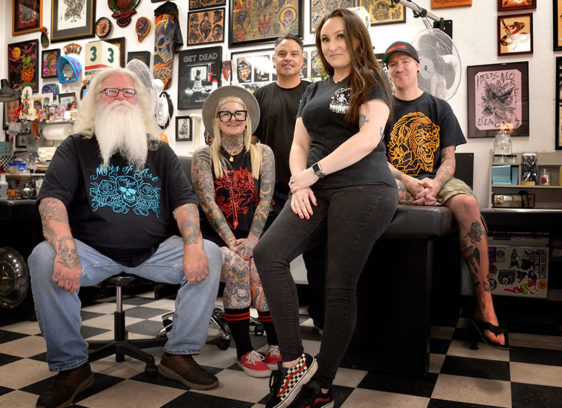 Group of people in a tattoo shop