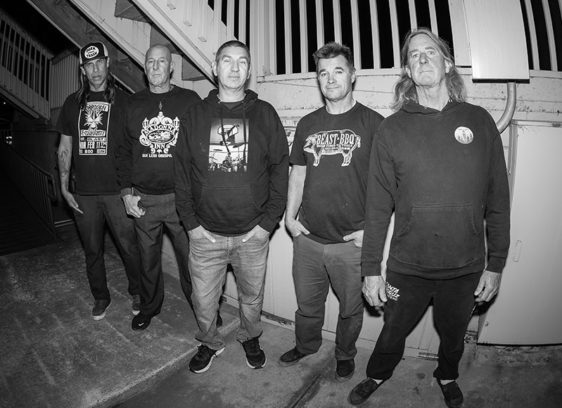 Five men posing in a stairwell