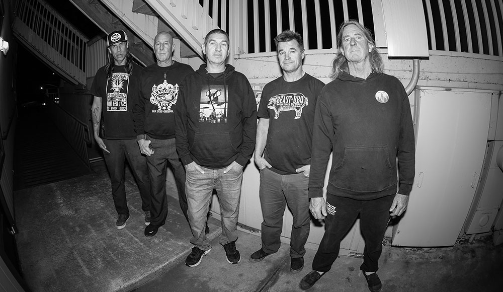 Five men posing in a stairwell