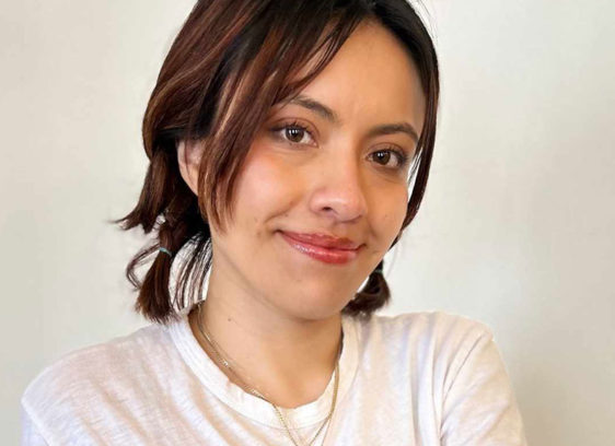 Woman wearing a white T-shirt and looking at the camera