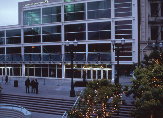 Multi-story building with many windows and stairs in front of it