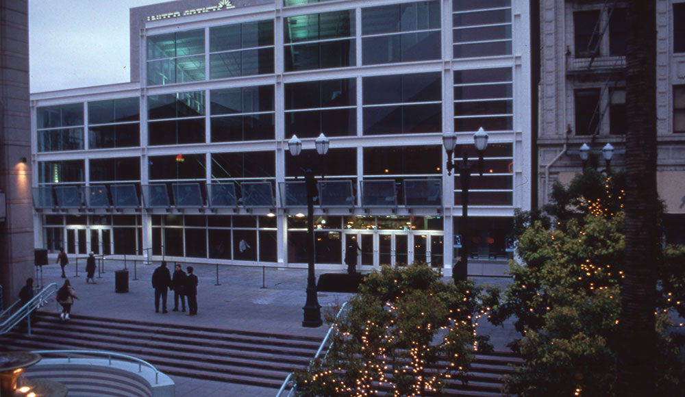 Multi-story building with many windows and stairs in front of it