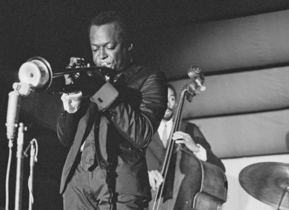 Man playing trumpet on a stage; black-and-white archival photo