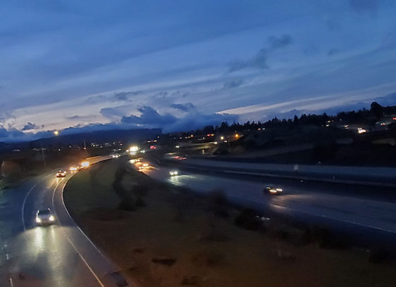 Freeway at twilight, cars driving with headlights