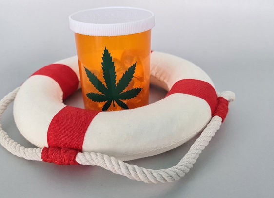 Prescription bottle marked with a marijuana leaf inside a lifesaver