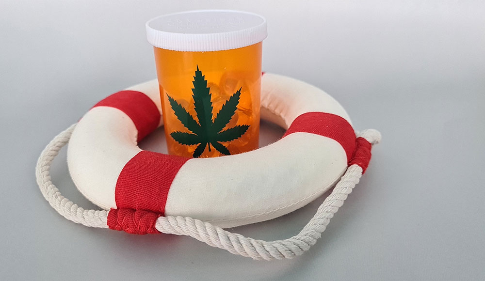 Prescription bottle marked with a marijuana leaf inside a lifesaver