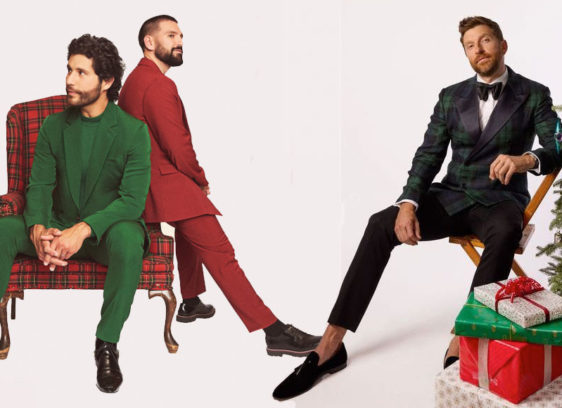 Three men and a Christmas tree on a light-colored background