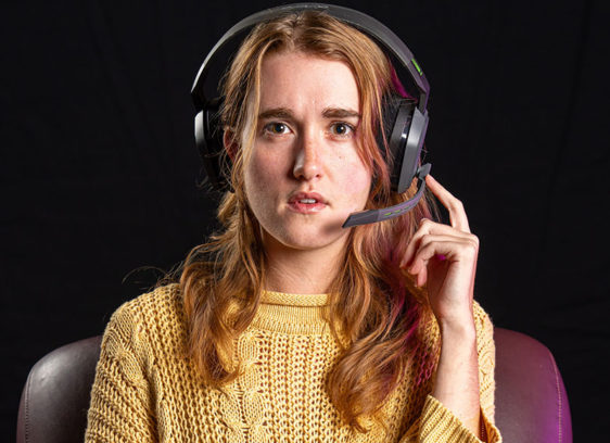 Woman wearing headphones looking straight at the camera