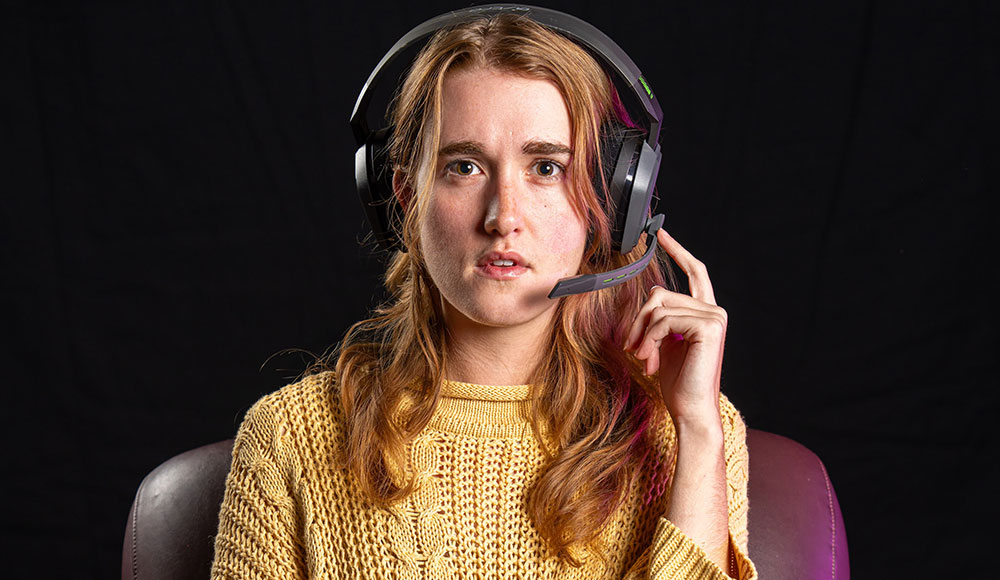 Woman wearing headphones looking straight at the camera