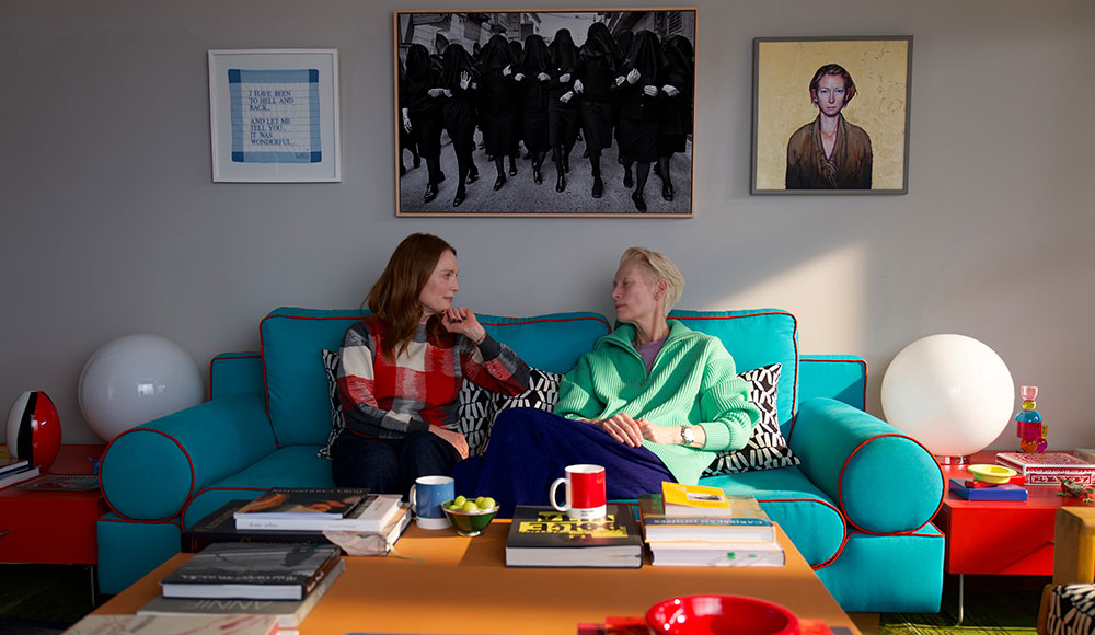 Two women on a couch in a living room