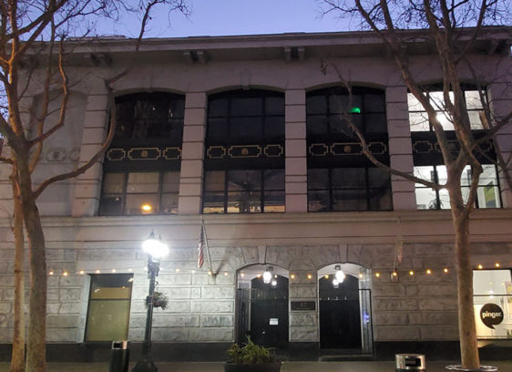 Photo of a building on a ciy street at dusk