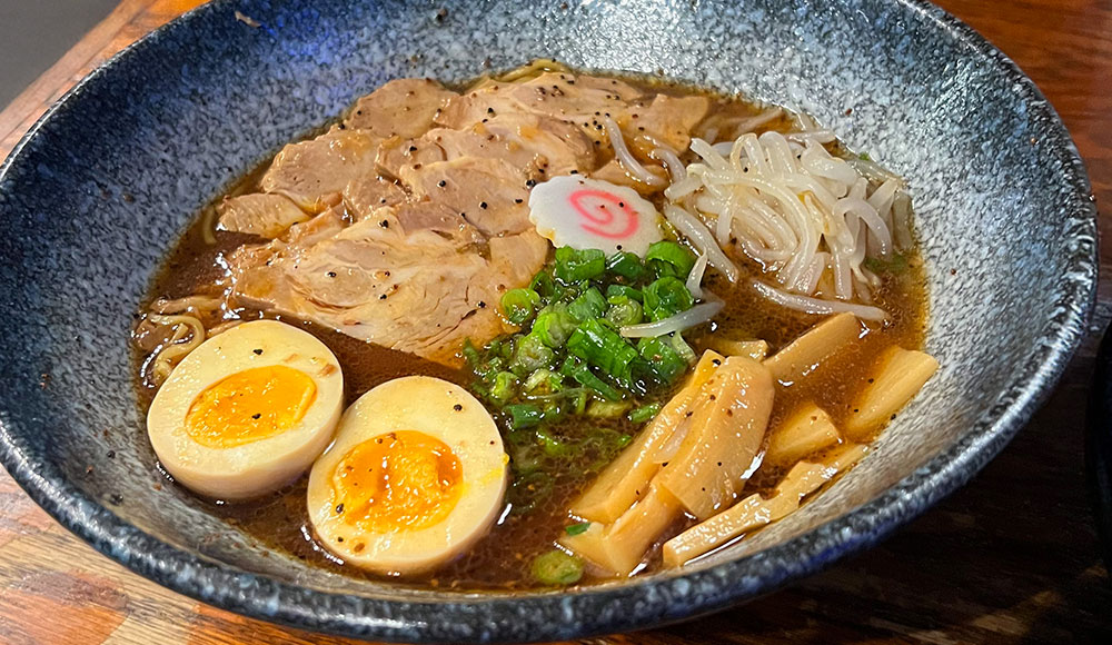 Big bowl of noodles,eggs,meat and garnishes