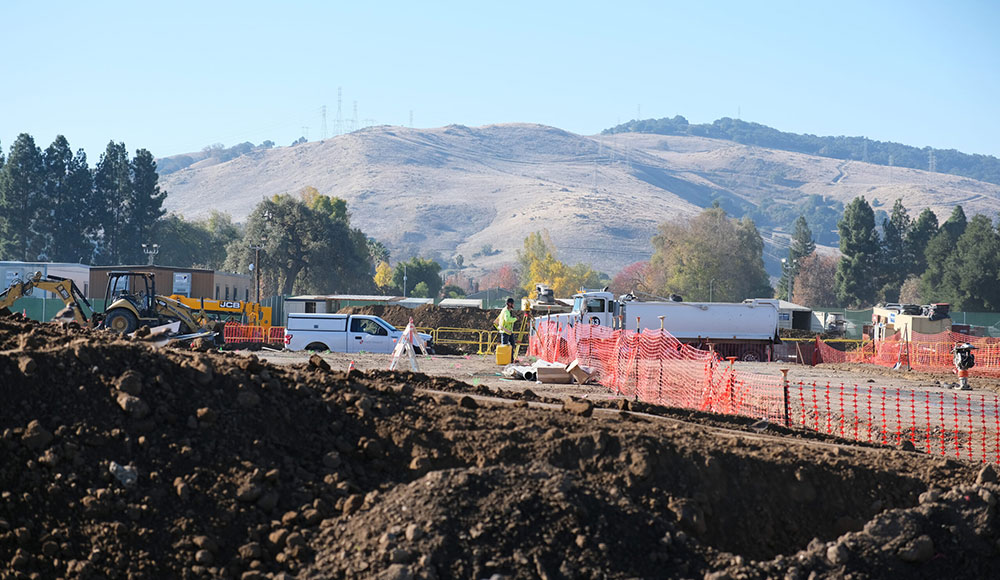 Construction site with mountain scenery behind it