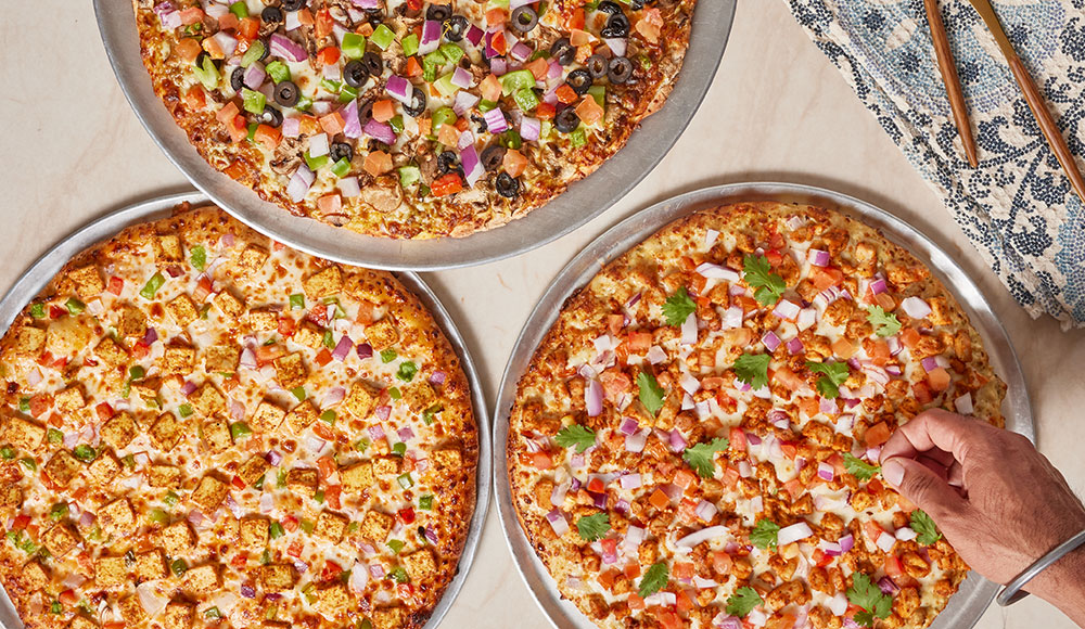 Three pizzas on a tabletop