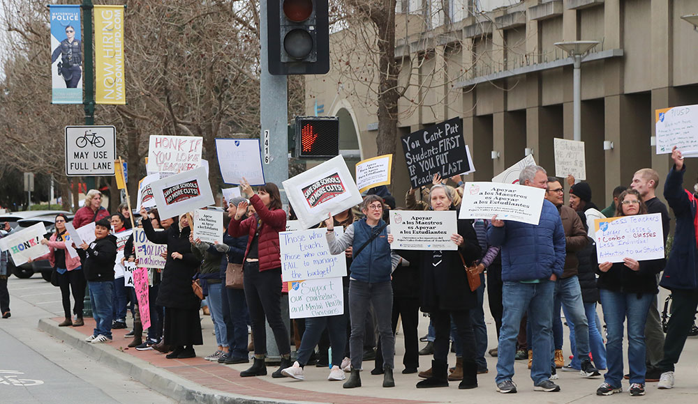 Protestors holding signs on a city street